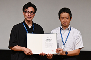 優秀論文講演後には，松原理事長が庄司氏に表彰状を授与
